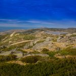 Breathtaking high-angle view of a mountain landscape under a vibrant blue sky.