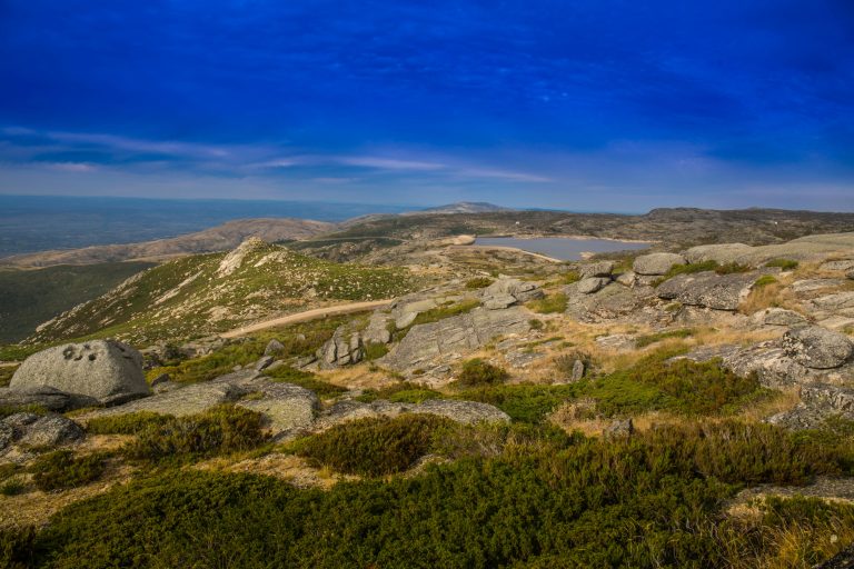 Breathtaking high-angle view of a mountain landscape under a vibrant blue sky.