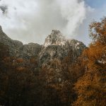 Majestic rocky mountains surrounded by autumn foliage in Manteigas, Portugal.