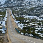 A tranquil road through a snow-covered landscape in Manteigas, Portugal.